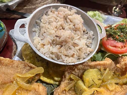 Coconut rice served with plantains and fish at En La Fonda in Panama. (NewsAmericasnow.com image)