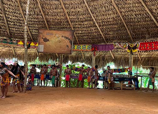 Embera dancers and musicians perform for tourist at their village up the Chagres River in Panama. (NewsAmericasNow.com image)