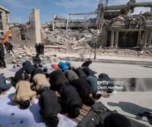 A group of Iranian men prays in an area that is targeted in U.S.-Israeli attacks in Tehran, Iran, on March 4, 2026.